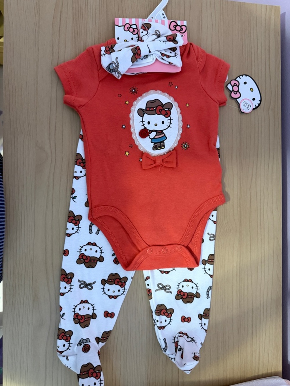 Hello Kitty Orange-Red Bodysuit with White Printed Footed Pants & Headband